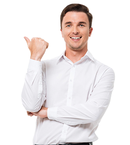 A man in a white dress shirt smiles and points with his thumb over his shoulder.